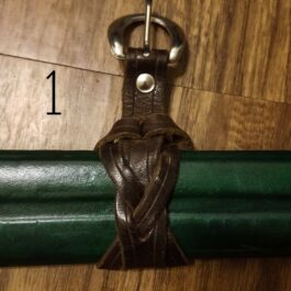 a close up of Universal Sword Suspension Straps on a wooden floor.