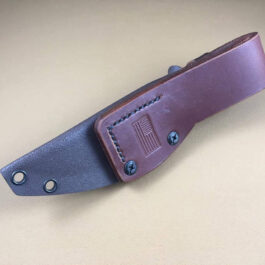 a Benchmade Saddle Mountain Skinner Kydex Sheath sitting on top of a table.