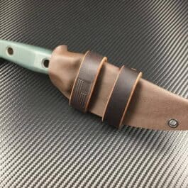 A Scout Style Benchmade Bushcrafter Kydex Sheath with a leather sheath on top of it.