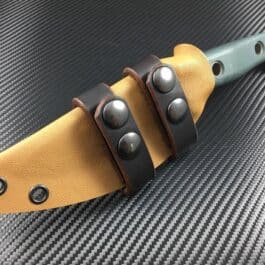 A close up of a Scout Style Benchmade Bushcrafter Kydex Sheath on a table.