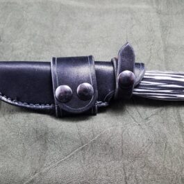 A Leather Scout Sheath for the Benchmade Saddle Mountain Skinner on a gray background.