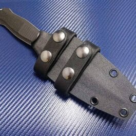 A close up of the Kydex Sheath for the Benchmade Fixed Infidel on a piece of luggage.