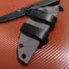 a Kydex sheath for the Benchmade Nim Cub II that is laying on a table.