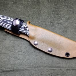 a Benchmade Saddle Mountain Skinner Kydex Sheath with a black handle.