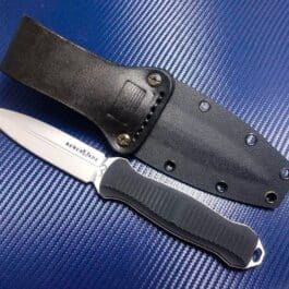 The Kydex Sheath for the Benchmade Fixed Infidel is laying on a blue surface.