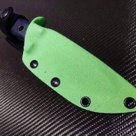 A close up of a Benchmade Bushcrafter Kydex Sheath on a black surface.