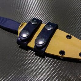 A close up of the Kydex sheath for the Benchmade Fixed Infidel on a table.