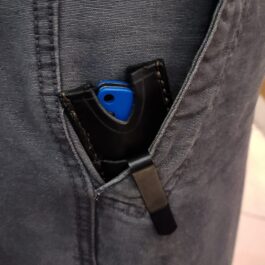 A leather pocket slip for the Benchmade Proper w' Pocket Clip sticking out of the pocket of a man's jeans.