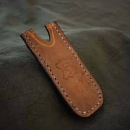 A brown Leather Pocket Slip for the Benchmade Tengu w' Pocket Clip with white stitching on it.