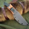 a knife is laying on a green cloth.