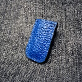 a Leather Sheath for Benchmade Balisong Knives laying on a gray surface.