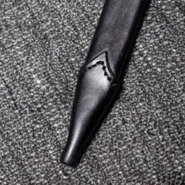 A Handmade leather Scabbard for the Albion Liechtenauer laying on top of a carpet.