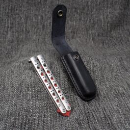 A Molded Leather Belt Pouch for a Benchmade Balisong sitting on top of a gray cloth.