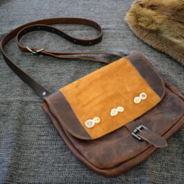 Arthur's Satchel sitting on top of a couch.