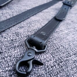 a close up of Upgraded Leather Suspenders on a carpet.