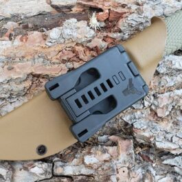 a knife that is laying on a rock.