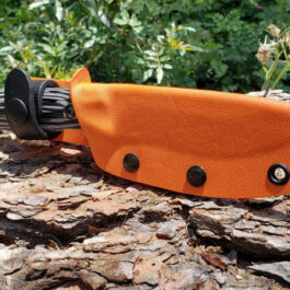 A close up of a Benchmade Saddle Mountain Skinner Kydex Sheath on a piece of wood.