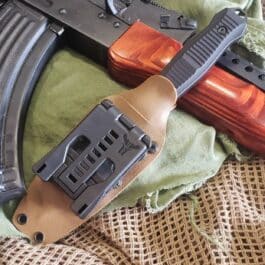 a Kydex Sheath for the Benchmade Fixed Infidel laying on top of a cloth.