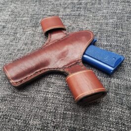A Handmade Leather Snap Loop Pancake Holster Style 2 with a blue handle.