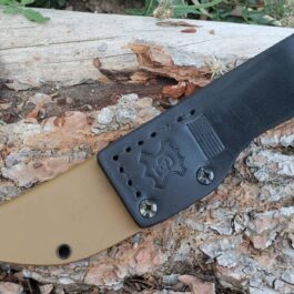 a knife that is laying on a piece of wood.