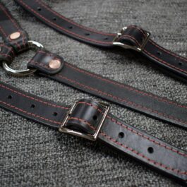a pair of Upgraded Leather Suspenders with red stitching.