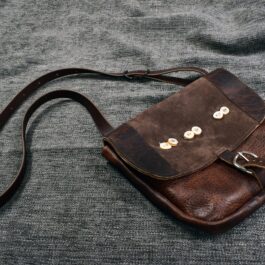 Arthur's Satchel sitting on top of a bed.