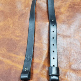 A black Simple Rifle Sling laid on a brown leather cloth - Grommet's Leathercraft - renaissance clothing - renaissance art clothing - renaissance era clothing - leathercraft supplies - leathercraft accessories - leathercraft store near me - quality leather craft