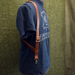 a man wearing a blue shirt with Handmade Leather Side Clip Suspenders.