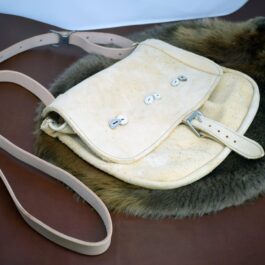 a white Arthur's Satchel with a fur trim around it.