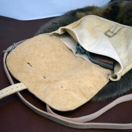 Arthur's Satchel is sitting on a table with a strap.