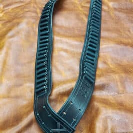 A Handmade Leather Bandolier is laying on a brown leather surface.