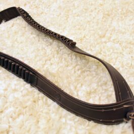 dark brown bandolier laid on a cloth - renaissance clothing - renaissance clothing men - renaissance clothing women - renaissance clothing near me - renaissance costume ideas - sword baldrics - baldrics leather - baldric belt