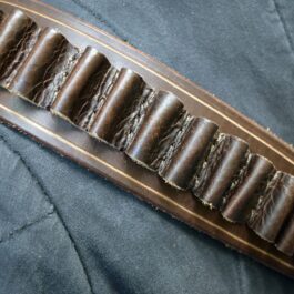 A close up of a person wearing a Handmade Leather Bandolier.