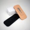 natural Hermann oak and black Leather Balisong Slip With Pocket Clip laid on a white table - renaissance clothing - renaissance clothing men - renaissance clothing women - renaissance clothing near me - renaissance art clothing - renaissance era clothing - renaissance costume ideas