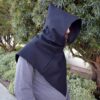 A man wearing a Wool Viking Hood is walking down a sidewalk.