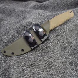 a knife that is laying on a cloth.