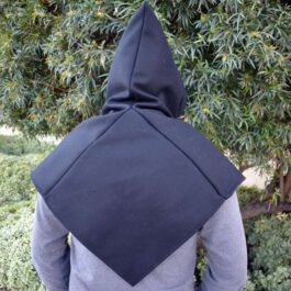 A person wearing a Wool Viking Hood standing in front of a tree.