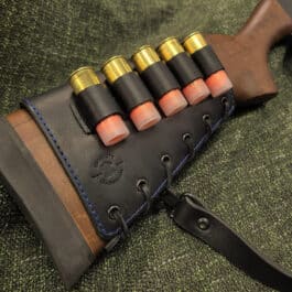 Upgraded Handmade Leather Rifle Buttstock Cover laid on a cloth - renaissance clothing - renaissance clothing men - renaissance clothing women - renaissance clothing near me - renaissance costume ideas - sword baldrics - baldrics leather - baldric belt