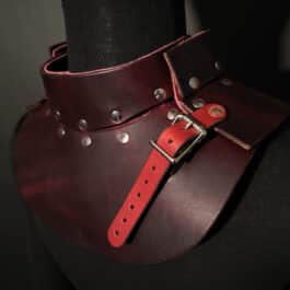a woman wearing an Upgraded Handmade Leather Buttstock Cover with metal rivets.