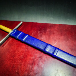 a Wood Core Scabbard for the Albion Liechtenauer sitting on top of a wooden table.