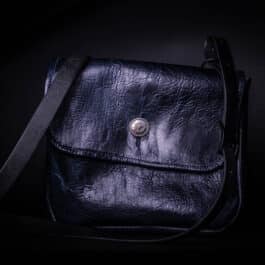 The "Outlaw" Bison Leather Saddlebag Satchel with a black strap.