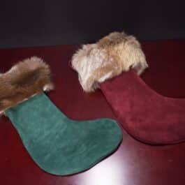 Handmade Reindeer Fur Christmas Stocking sitting on a table.
