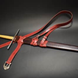 A custom wood core scabbard on a black surface.