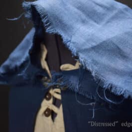 a Linen Hooded Cloak with a tie on it.