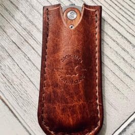 a Handmade Bison Leather Pocket Slip with a metal button on it.
