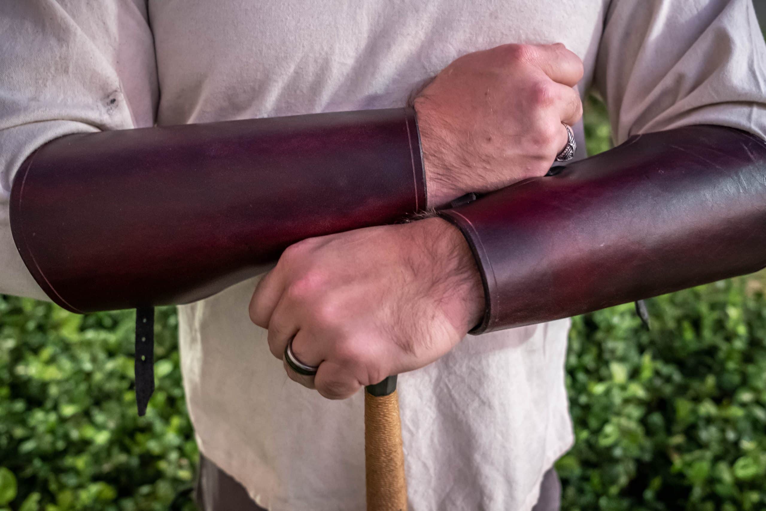 A man holding the "Operator" Gunbelt with Cobra Buckle in his hand.