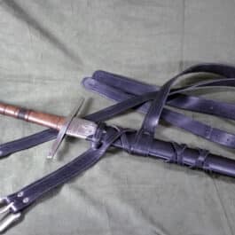 a pair of scissors laying on top of a bed.