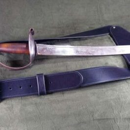 a pair of swords laying on top of a table.