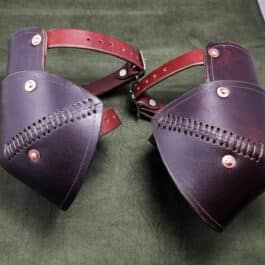 a pair of leather garbs on a green surface.