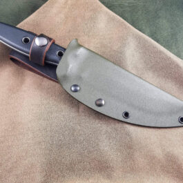 a knife that is laying on a cloth.